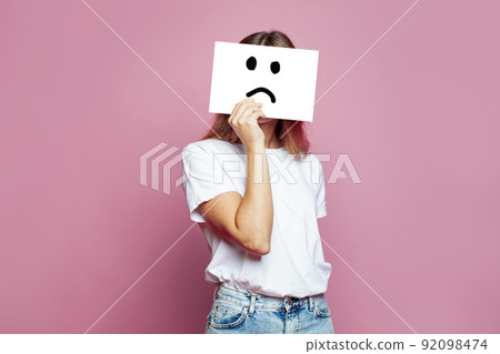 Sad woman hiding her face on pink background Sad woman hiding her face on pink background 92098474