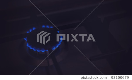 Closeup of blue gas flame on domestic kitchen stove. Gas cooker with burning flames 92100679