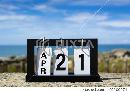 calendar date text on wooden frame with blurred background of ocean. calendar date text on wooden frame with blurred background of ocean. 92100974