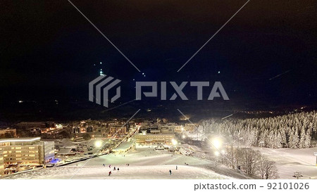Illuminated night game Niseko Hirafu ski area and the scenery of the lights of hotels and buildings at the foot of the mountain 92101026