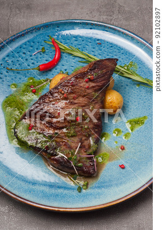 marbled beef steak with new potatoes and green butter 92102897