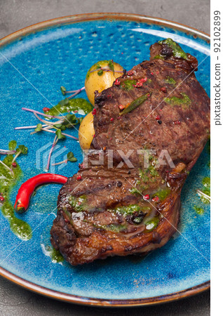 marbled beef steak with new potatoes and green butter marbled beef steak with new potatoes and green butter 92102899