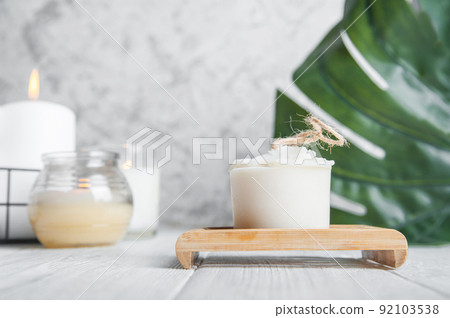 Natural loofah scrubber on podium in bathroom. Zero waste in life. Relaxation spa concept, candles, beauty.. Natural loofah scrubber on podium in bathroom. Zero waste in life. Relaxation spa concept, candles, beauty.. 92103538