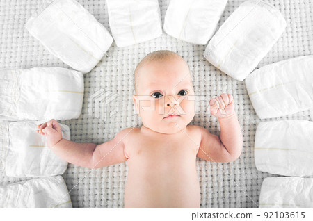 Newborn and diapers close up. Baby care concept.. Newborn and diapers close up. Baby care concept.. 92103615