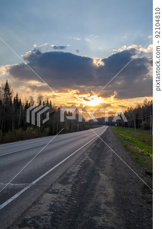 Country road with markings in the middle of the forest. 92104810