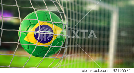Football ball with flag of Brazil in the net of goal of football stadium. Football championship of Brazil concept. Football ball with flag of Brazil in the net of goal of football stadium. Football championship of Brazil concept. 92105575