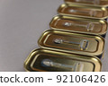 Close-up of metal canning tins against a gray background. Rectangular containers of canned food. Selective focus. 92106426
