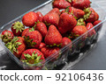 Ripe strawberries close-up. A new crop of sweet berries in a transparent tray. Healthy Food. Selective focus. 92106436
