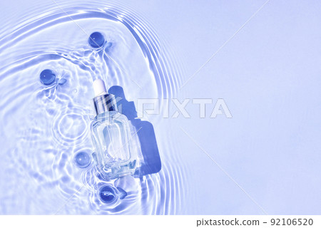 Mockup of cosmetic glass blue bottle with pipette and serum on water surface with waves 92106520
