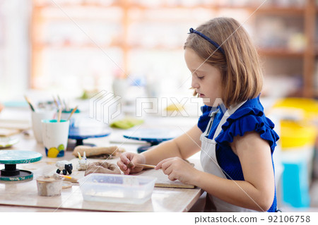 Child at pottery wheel. Kids arts and crafts class Child at pottery wheel. Kids arts and crafts class 92106758