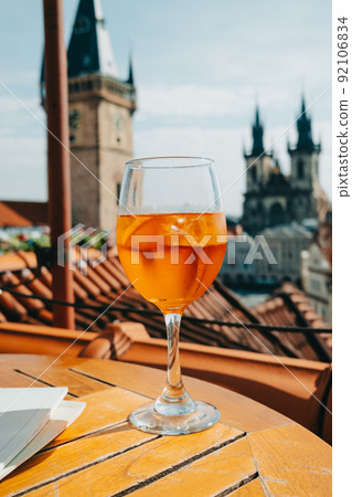 Aperol Spritzes cocktail on background of old Prague town square with Church, astronomical clock 92106834