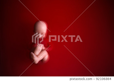 Abortion concept. Baby doll in the red blood looks like abortation. 92106864