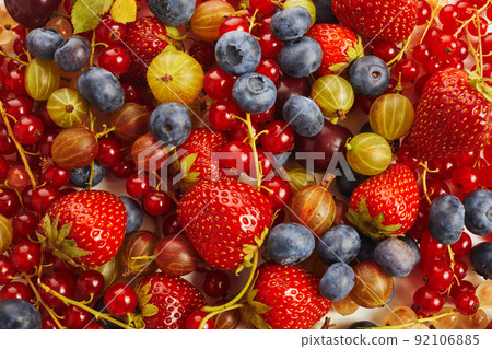 Berries overhead colorful assorted mix of strawberry, blueberry, red currant. Berries overhead colorful assorted mix of strawberry, blueberry, red currant. 92106885