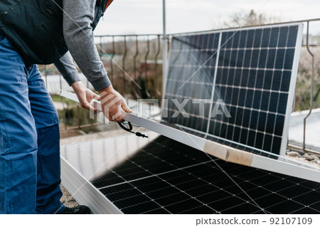 Close up of man holding solar panel. Eco concept alternative energy Close up of man holding solar panel. Eco concept alternative energy 92107109