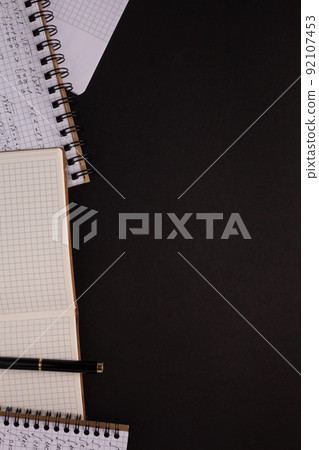 Paper notebook on black background texture. Creative idea concept Paper notebook on black background texture. Creative idea concept 92107453