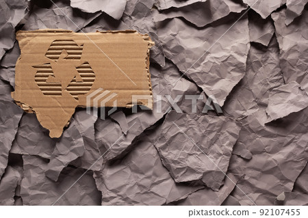 Recycle symbol on parcel paper as background texture. Recycling concept and brown cardboard Recycle symbol on parcel paper as background texture. Recycling concept and brown cardboard 92107455
