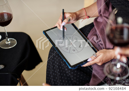 Astrologer Drawing Natal Card on Tablet Astrologer Drawing Natal Card on Tablet 92108484