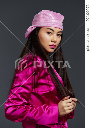 pretty woman in a pink mini dress pink headscarf luxury close-up studio model 92109071