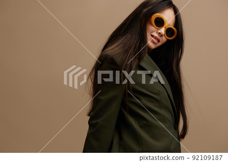 portrait woman in a stylish suit in black glasses posing beige background portrait woman in a stylish suit in black glasses posing beige background 92109187