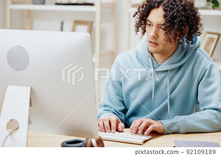 portrait of a man in a blue jacket in front of a computer Lifestyle portrait of a man in a blue jacket in front of a computer Lifestyle 92109189