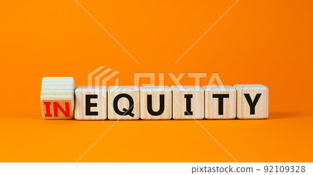 Inequity or equity symbol. Turned wooden cubes and changed the concept word Inequity to Equity. Beautiful orange table orange background. Business and inequity or equity concept. Copy space. Inequity or equity symbol. Turned wooden cubes and changed the concept word Inequity to Equity. Beautiful orange table orange background. Business and inequity or equity concept. Copy space. 92109328