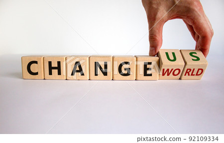 Change world or us symbol. Businessman turns wooden cubes and changes words 'change world' to 'change us'. Beautiful white background, copy space. Business and change yourself concept. 92109334