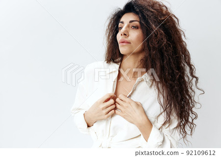 Close up portrait Curly Pretty Pensive Latin Female Lady Zipping White Shirt Touching Collar copy space, free place Looking Aside Isolated At White Studio Wall Background. Good Offer, Banner, Mockup Close up portrait Curly Pretty Pensive Latin Female Lady Zipping White Shirt Touching Collar copy space, free place Looking Aside Isolated At White Studio Wall Background. Good Offer, Banner, Mockup 92109612