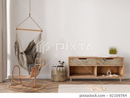 Empty wall in modern child room. Mock up interior in boho style. Copy space for your picture or poster. Wooden sideboard, rattan basket, hanging armchair, toys. Cozy room for kids. 3D rendering. Empty wall in modern child room. Mock up interior in boho style. Copy space for your picture or poster. Wooden sideboard, rattan basket, hanging armchair, toys. Cozy room for kids. 3D rendering. 92109764