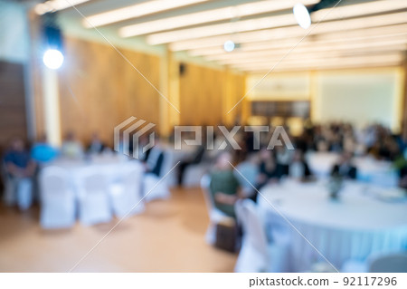 Blurry seminar hall with audience student in it. This room are arranged by round circle group table that appropriate for workshop. Blurry seminar hall with audience student in it. This room are arranged by round circle group table that appropriate for workshop. 92117296