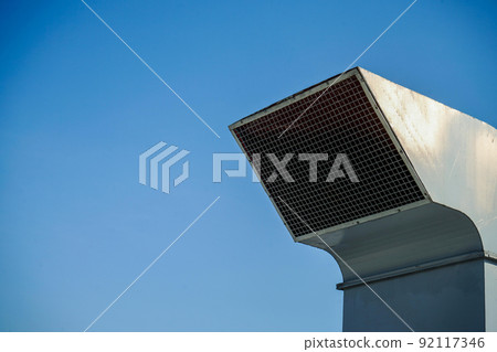 The industrial machine at the rooftop of the huge building. 92117346