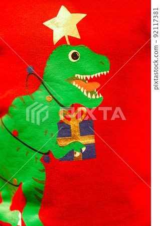 Creative green T-Rex Christmas tree print screen on on knitting sweater. Creative green T-Rex Christmas tree print screen on on knitting sweater. 92117381