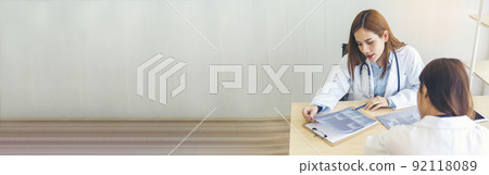 Banner Two asian women doctors discuss meeting office medical clinic. Young asian female doctor looking x-ray film consulting patient disease together. Panorama Asian medical care lab with copy space 92118089