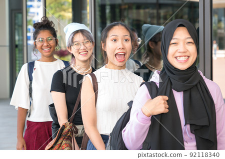 Group of happy young women standing in a row. Group of happy young women standing in a row. 92118340