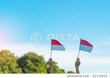 hand holding Indonesia flag on blue sky background. Indonesia independence day, National holiday Day and happy celebration concepts 92118433