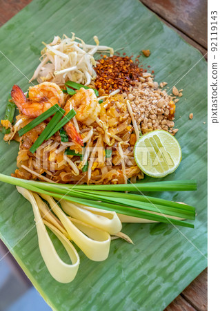 PadThai, The Traditional of Thailand Fried noodle with prawns on the banana leaf ready to serve for lunch. PadThai, The Traditional of Thailand Fried noodle with prawns on the banana leaf ready to serve for lunch. 92119143