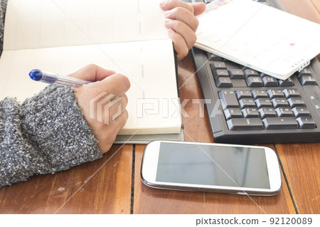 notebook planner with working woman for business work  92120089