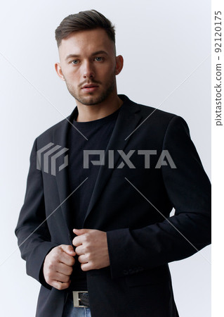 Modelling snapshots. Serious self-confident attractive handsome man in classic suit wear jacket posing isolated in white studio background. Fashion offer. Copy space for ad Modelling snapshots. Serious self-confident attractive handsome man in classic suit wear jacket posing isolated in white studio background. Fashion offer. Copy space for ad 92120175