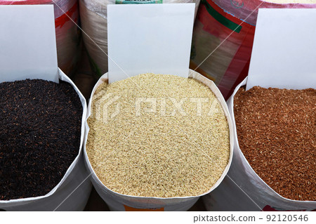 Top view,Piles of Black,Yellow and Red Rice,unpolished grain,Thai aromatic rice in the sacks at market,grocery store,Khao Hom Mali Jasmine Husked or Organic Brown Rice,nutrition,healthy food concept 92120546