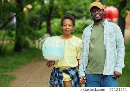Dad walking with his son in park 92121321