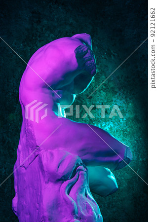 Gypsum copy of Belvedere Torso statue for artists. Replica of a famous ancient Greek fragmentary marble sculpture of male nude in color neon light. Template design for art, dj, fashion, poster, zine. 92121662