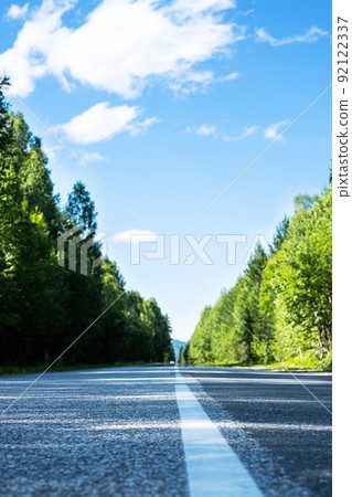 Empty road. Speedway without cars in mountains amid pine forests. Adventure or road trip background. 92122337
