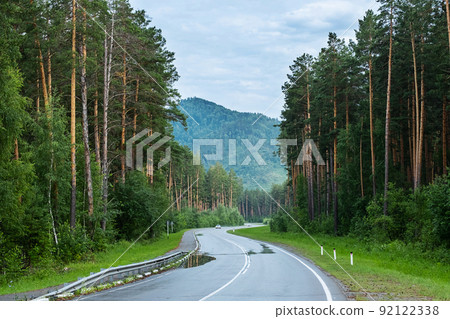 Empty road. Speedway without cars in mountains amid pine forests. Adventure or road trip background. 92122338