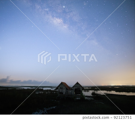 Milky Way early morning before sunrise , old abandoned house, red roof on open field Milky Way early morning before sunrise , old abandoned house, red roof on open field 92123751