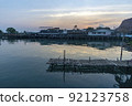 Fisherman's house and seaside house in Sattahip, reflecting with the water surface. Bright sky 92123758