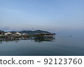 Fisherman's house and seaside house in Sattahip, reflecting with the water surface. Bright sky 92123760