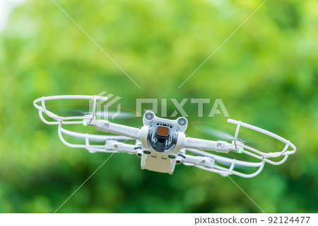 Drone in flight fresh green Drone in flight fresh green 92124477