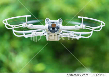 Drone in flight fresh green Drone in flight fresh green 92124482