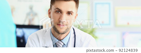 Attractive young medical worker in white uniform, wait patient for planned appointment Attractive young medical worker in white uniform, wait patient for planned appointment 92124839