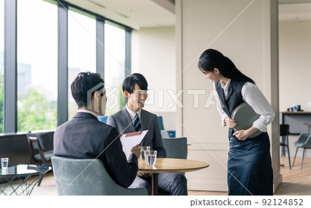 Waitress serving customers at a restaurant Waitress serving customers at a restaurant 92124852