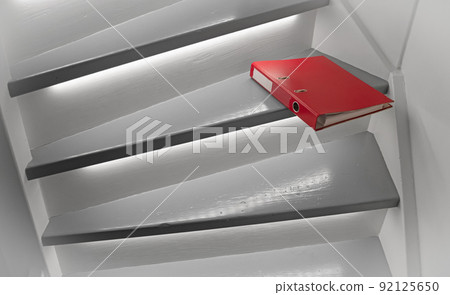 Red file on the stairs, selective focus 92125650